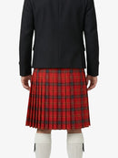 Person wearing a black jacket and red plaid kilt on a white background
