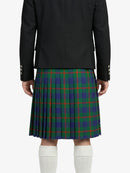Person wearing a black jacket and green plaid kilt on a white background