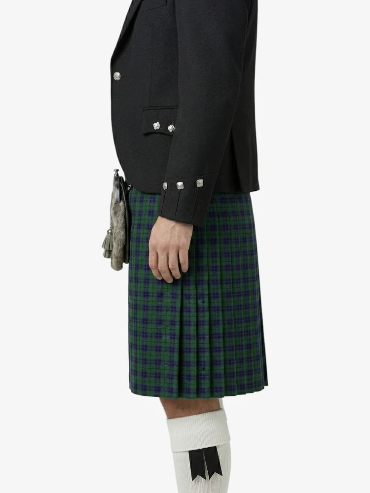 Person wearing a black jacket and green plaid kilt on a white background