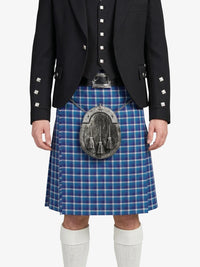Person wearing a blue plaid kilt with a black jacket on a white background