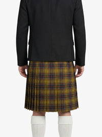 Person wearing a black jacket and plaid kilt on a white background
