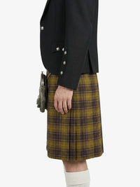 Person wearing a black jacket and plaid kilt on a white background