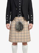 Person wearing a black jacket, beige plaid kilt, and white socks on a white background