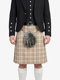 Person wearing a black jacket, beige plaid kilt, and white socks on a white background