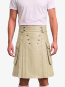 A model wearing a light beige faux-leather kilt with silver-tone decorative buttons and side flap pockets, paired with a light pink t-shirt against a plain white background.