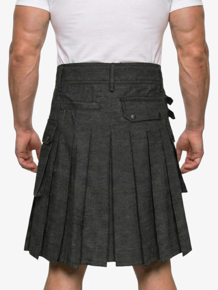Person wearing a gray pleated kilt on a white background