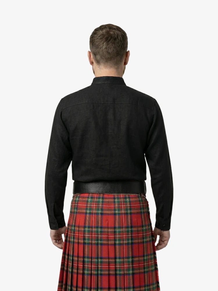 Man wearing a black shirt and red plaid kilt on a white background