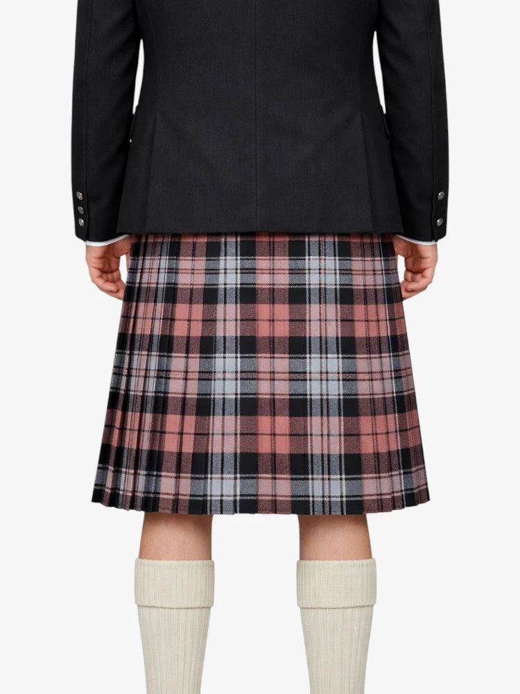 Person wearing a black jacket and plaid kilt on a white background