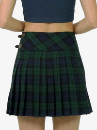 Green plaid skirt worn by a person on a white background