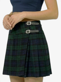 Plaid skirt with silver buckles worn by a person on a white background