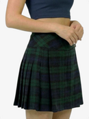 Person wearing a green plaid skirt on a white background