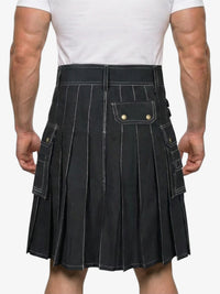 Person wearing a black pleated kilt on a white background