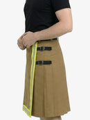 Person wearing a tan kilt with reflective yellow strip on a white background
