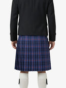 Person wearing a black jacket and blue plaid kilt on a white background