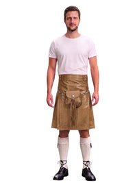 A man modeling a tan faux-leather kilt with a matching belt and pouch, paired with a white t-shirt, white knee-high socks, and black lace-up shoes, against a plain white background.