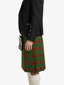 Person wearing a black jacket and green plaid kilt on a white background