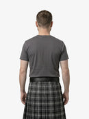 Man wearing a gray t-shirt and plaid kilt on a white background