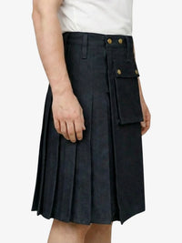 Person wearing a black pleated skirt with gold buttons on a white background