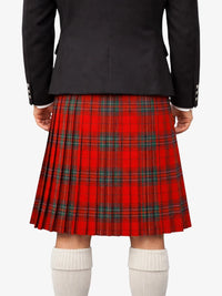 Person wearing a red plaid kilt with a black jacket on a white background