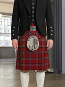 Person wearing a traditional Scottish kilt with a jacket indoors.