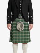 Person wearing a green plaid kilt with a black jacket on a white background