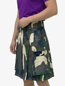 Person wearing a camouflage kilt on a white background