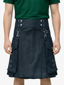 Person wearing a dark blue kilt with metal rings on a plain background