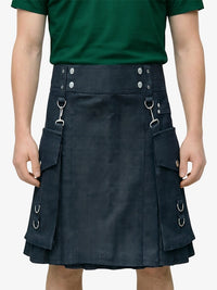 Person wearing a dark blue kilt with metal rings on a plain background