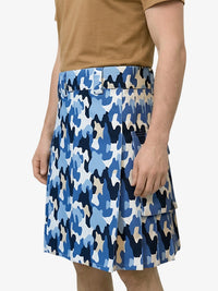 Person wearing a blue camouflage skirt on a white background