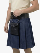 Person wearing a navy blue kilt with black leather accents on a white background