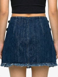 Blue denim skirt worn by a person on a white background