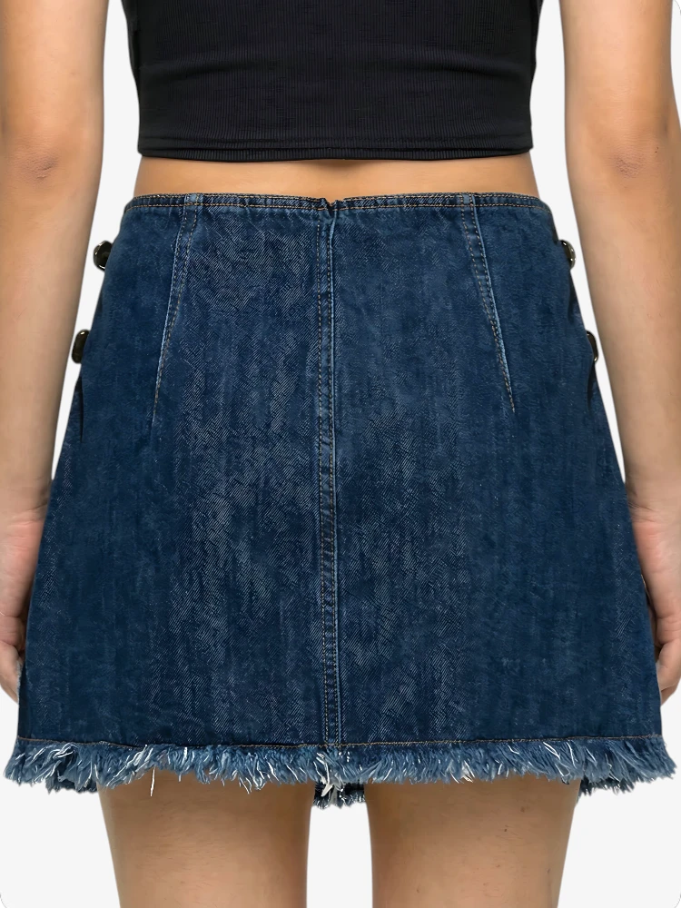Blue denim skirt worn by a person on a white background
