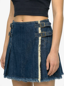Denim skirt with metal buckles worn by a person on a white background
