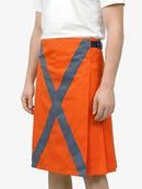 Orange skirt with reflective gray stripes worn by a person on a white background