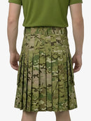 Person wearing a green pleated skirt with a camouflage pattern on a white background