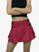 Person wearing a red skirt with black accents on a white background