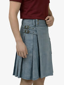 Person wearing a blue denim kilt on a white background