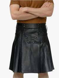 Person wearing a black leather kilt with a plain background