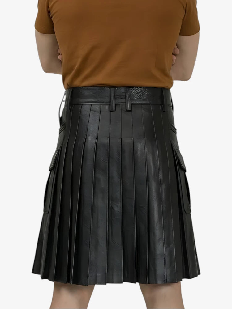 Person wearing a brown top and black pleated leather skirt on a white background