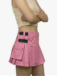 Pink skirt with black accents worn by a person on a white background