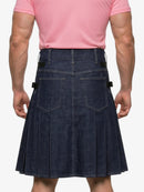 Person wearing a pink shirt and denim kilt on a white background