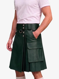 A dark green faux-leather kilt with a matching belt, silver-tone hardware, and a large front cargo pocket, shown on a model wearing a light pink t-shirt against a white background.
