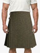 Man wearing a brown herringbone kilt on a plain background