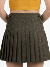 Brown pleated skirt worn by a person on a white background
