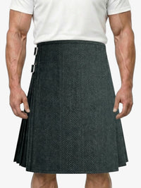 Person wearing a gray patterned kilt on a white background