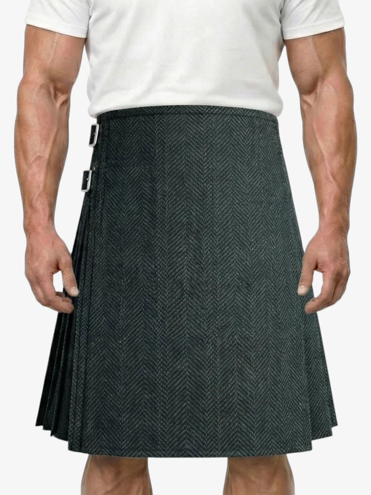 Person wearing a gray patterned kilt on a white background