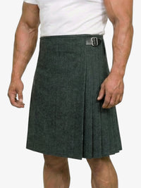 Person wearing a green pleated kilt on a white background