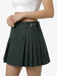Dark gray pleated skirt worn by a person on a white background