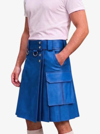 A person wearing a bright blue pleated leather kilt with a matching belt, silver-tone hardware, and large front cargo pockets, paired with a light pink t-shirt against a plain light background.