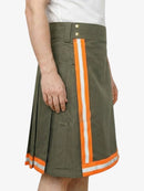Green skirt with orange and white stripes worn by a person on a white background